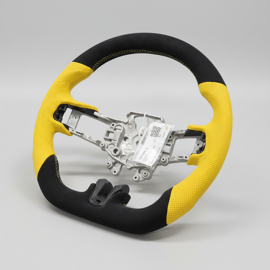 A black and yellow Alcantara steering wheel with yellow Nappa perforated leather hand grips, designed for a Mustang GT.