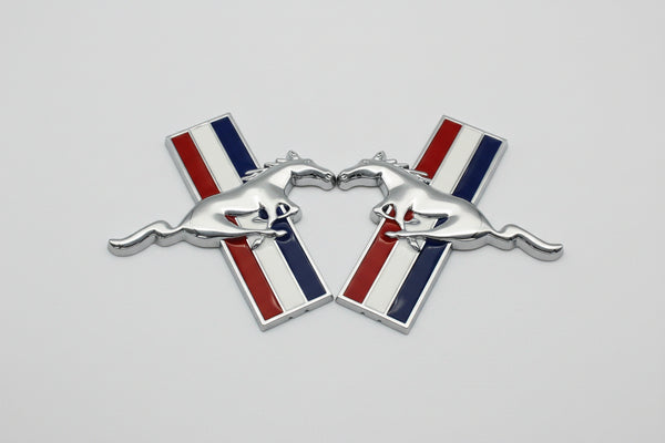 A set of two chrome fender badges for a vehicle, featuring a horse silhouette design with a blue background, red accents, and a white border.