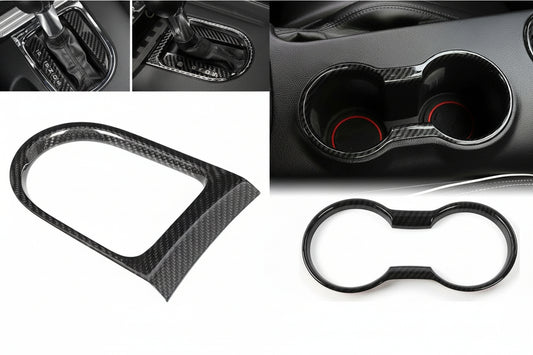 Carbon fiber car interior accessories including a gear shift cover, cup holder, and frame.